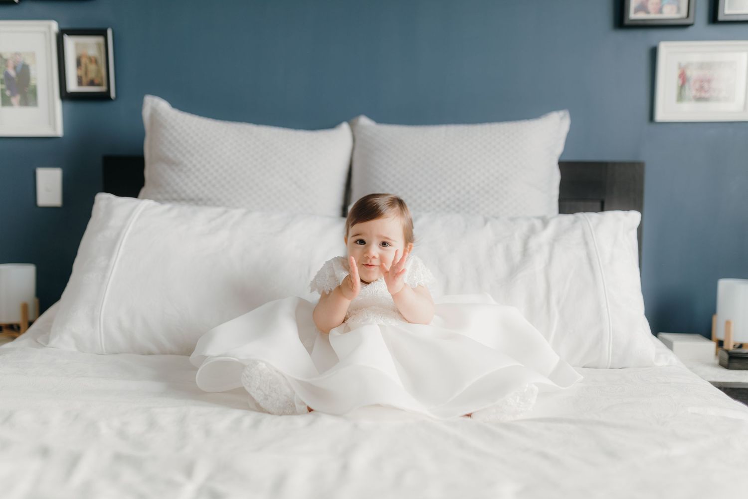christening photos of baby girl on bed