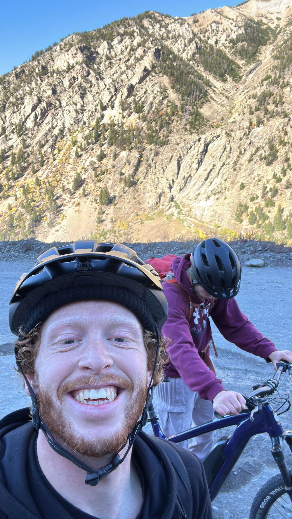 Mountain biking adventure near steep rocky cliffs beside a scenic mountain lake.