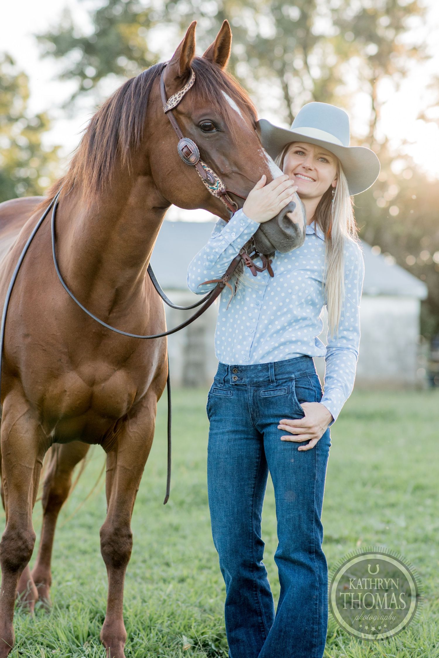 A portrait showing an affectionate moment between a brown horse and its handler in western attire.