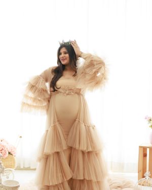 A maternity portrait featuring a champagne-colored tulle gown and crown.