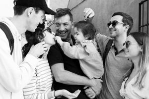 Group sharing laughter and joy in black and white candid photo.