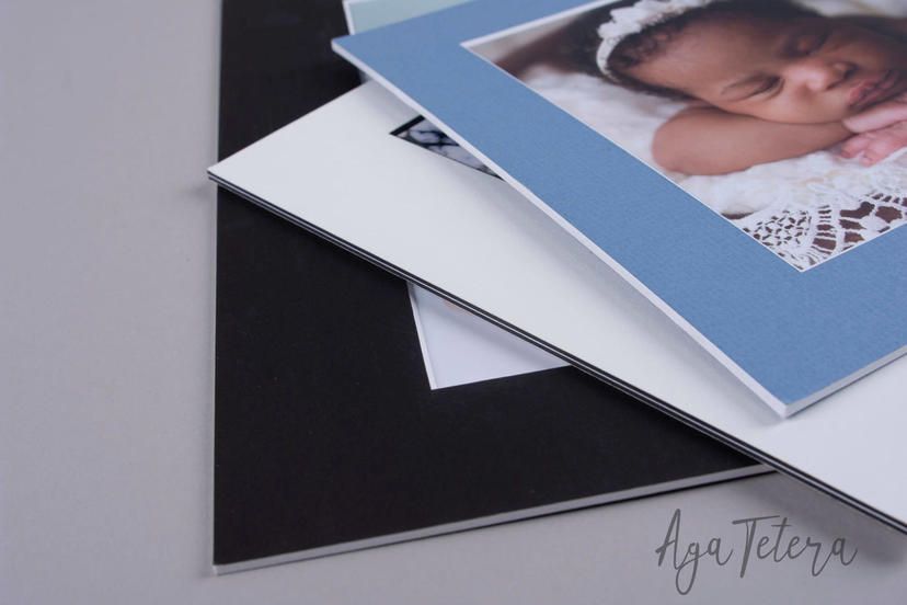 Detail shot of professional photo prints stacked on dark background.