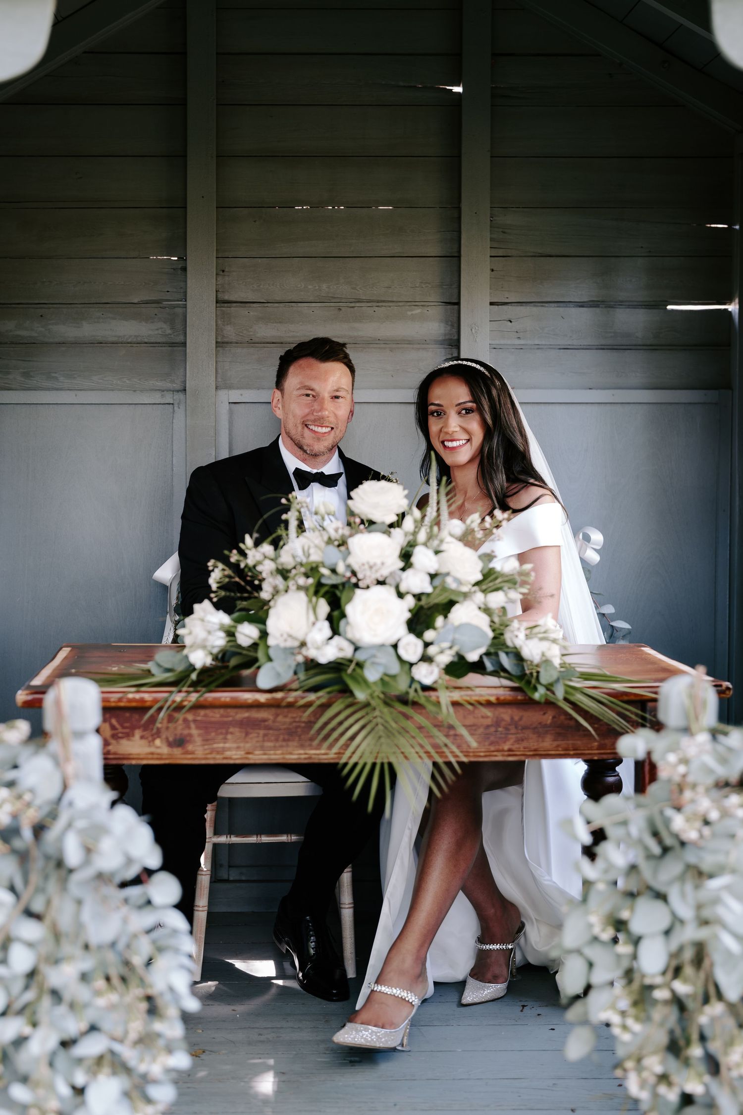 bride-and-groom-signing-register-stockton-house-outdoor-wedding-ceremony