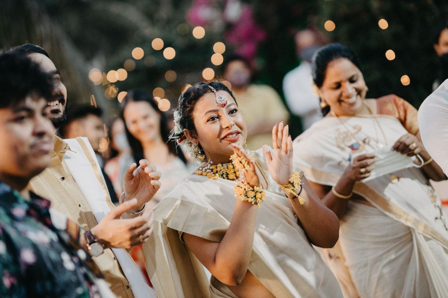 Festive celebration with people dancing and enjoying themselves under evening lights.