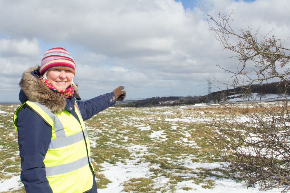 June D., a campaigner from The Campaign to Protect Pont Valley, pointing across the field to the nearest houses.
