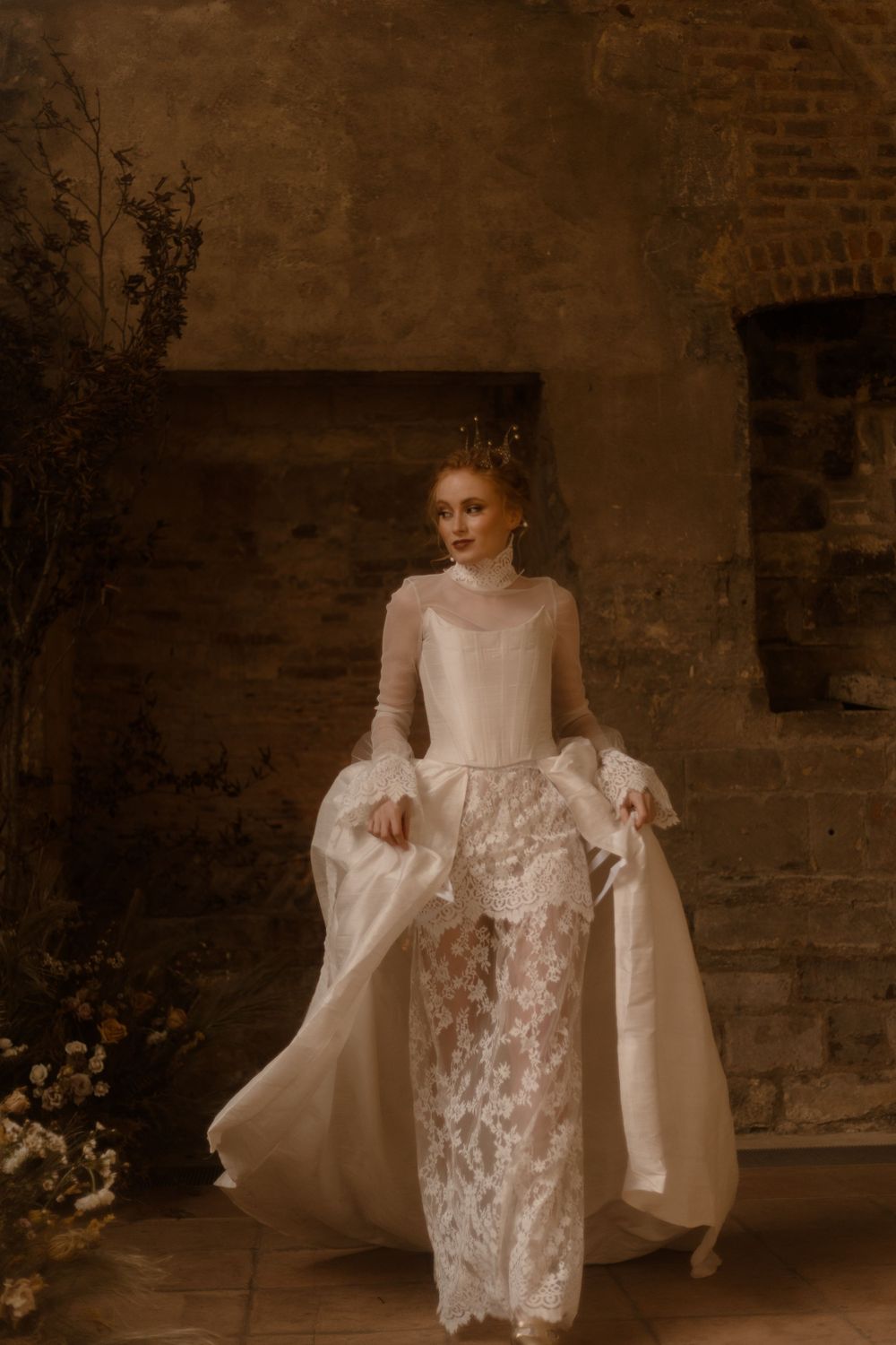 Romantic bridal portrait showcasing vintage-inspired gown with lace details in rustic setting.