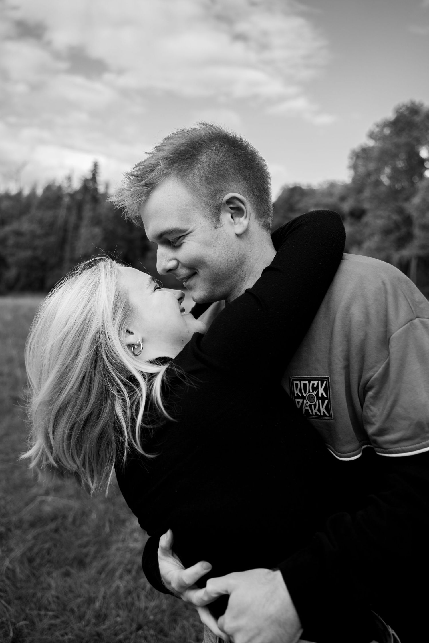 A romantic black and white photo sequence showing a couple embracing outdoors.