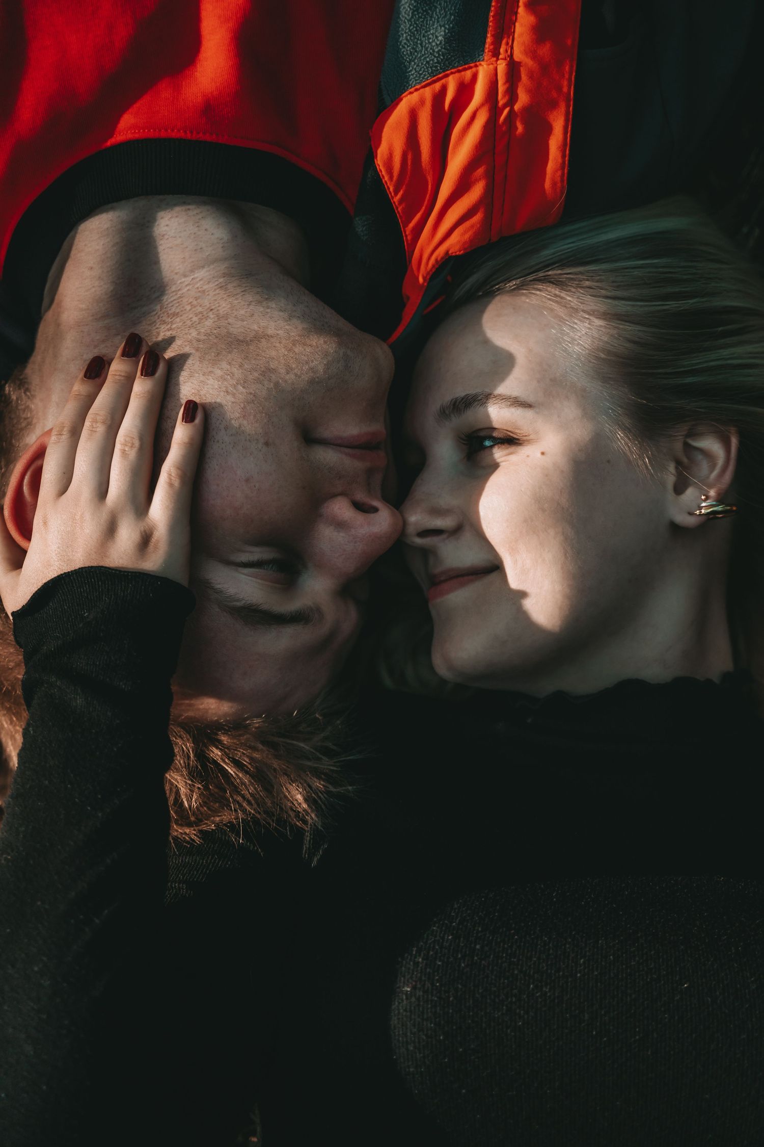 Artistic dark photography sequence featuring red clothing and intimate poses.