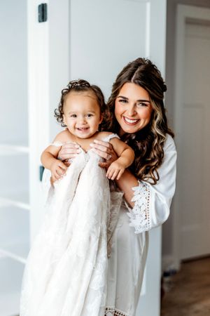 Tender moment between bride/mom in white dress and small child in matching white outfit.Middle TN wedding photographer