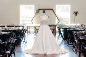 Modern wedding reception venue with elegant table settings and white wedding dress.  Middle TN wedding photographer