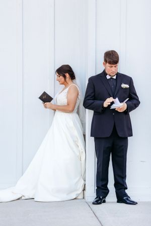 Artistic wedding photo series against a white wall showing a bride in white dress and groom in dark suit. Middle TN wedding photographer