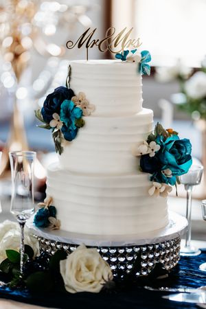 Elegant white wedding cake decorated with teal blue roses and Mr & Mrs topper.Middle TN wedding photographer