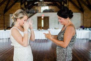 Wedding party members sharing emotional moments before the ceremony in an indoor venue.Middle TN wedding photographer