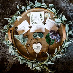 Wedding detail shots of eucalyptus leaves and handwritten notes arranged on wooden surface.Middle TN wedding photographer