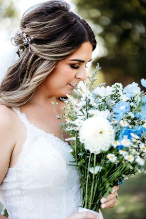 Close-up of white wedding bouquet with delicate flowers against natural outdoor backdrop. Middle TN wedding photographer