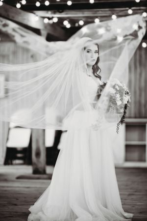 Flowing white wedding dress creates dramatic movement in black and white photography. Middle TN wedding photographer
