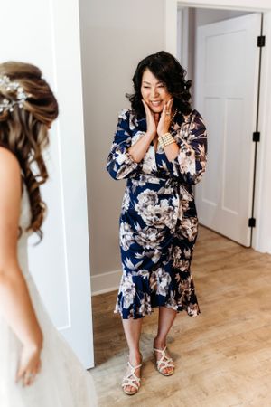 Person in floral navy blue robe preparing for wedding day celebrations. Middle TN wedding photographer