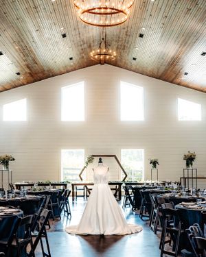 Spacious rustic wedding venue with vaulted wooden ceiling and elegant table arrangements. Middle TN wedding photographer
