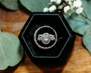 Wedding rings displayed in black hexagonal ring boxes with elegant styling. Middle TN wedding photographer