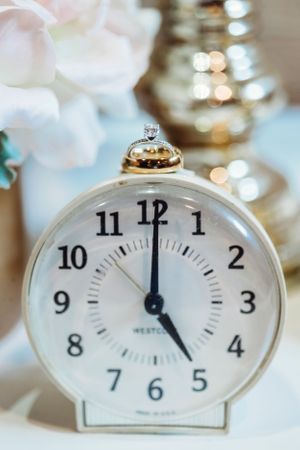 A series of vintage alarm clocks showing different times arranged on a blurred background. Middle TN wedding photographer
