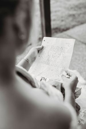 Close-up shots of handwritten wedding vows on paper with a ring in black and white.Middle TN wedding photographer