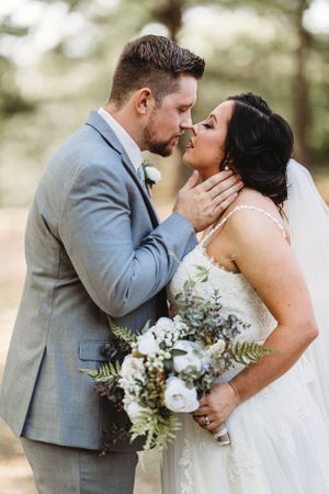 A romantic wedding photo sequence showing a couple sharing their first kiss in formal attire against a soft outdoor backdrop. Middle TN wedd
