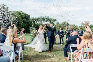 Wedding party and guests throwing confetti during an outdoor celebration.Middle TN wedding photographer