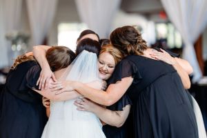 Wedding guests sharing heartfelt hugs and embraces during a celebration. Middle TN wedding photographer