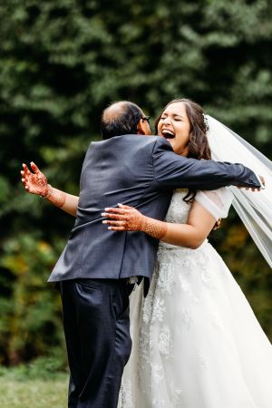 Emotional wedding day embrace captured in an outdoor garden setting. Middle TN wedding photographer