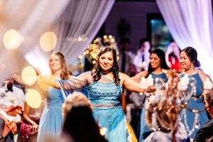 Wedding reception dance floor filled with guests in blue dresses celebrating.Middle TN wedding photographer