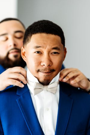 A series of four portrait photos showing a person in a white shirt and blue blazer expressing different emotions. Middle TN wedding photogra