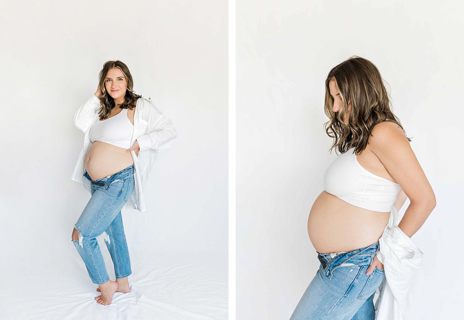 Casual maternity photos showing pregnancy belly with white top and ripped jeans in studio setting.