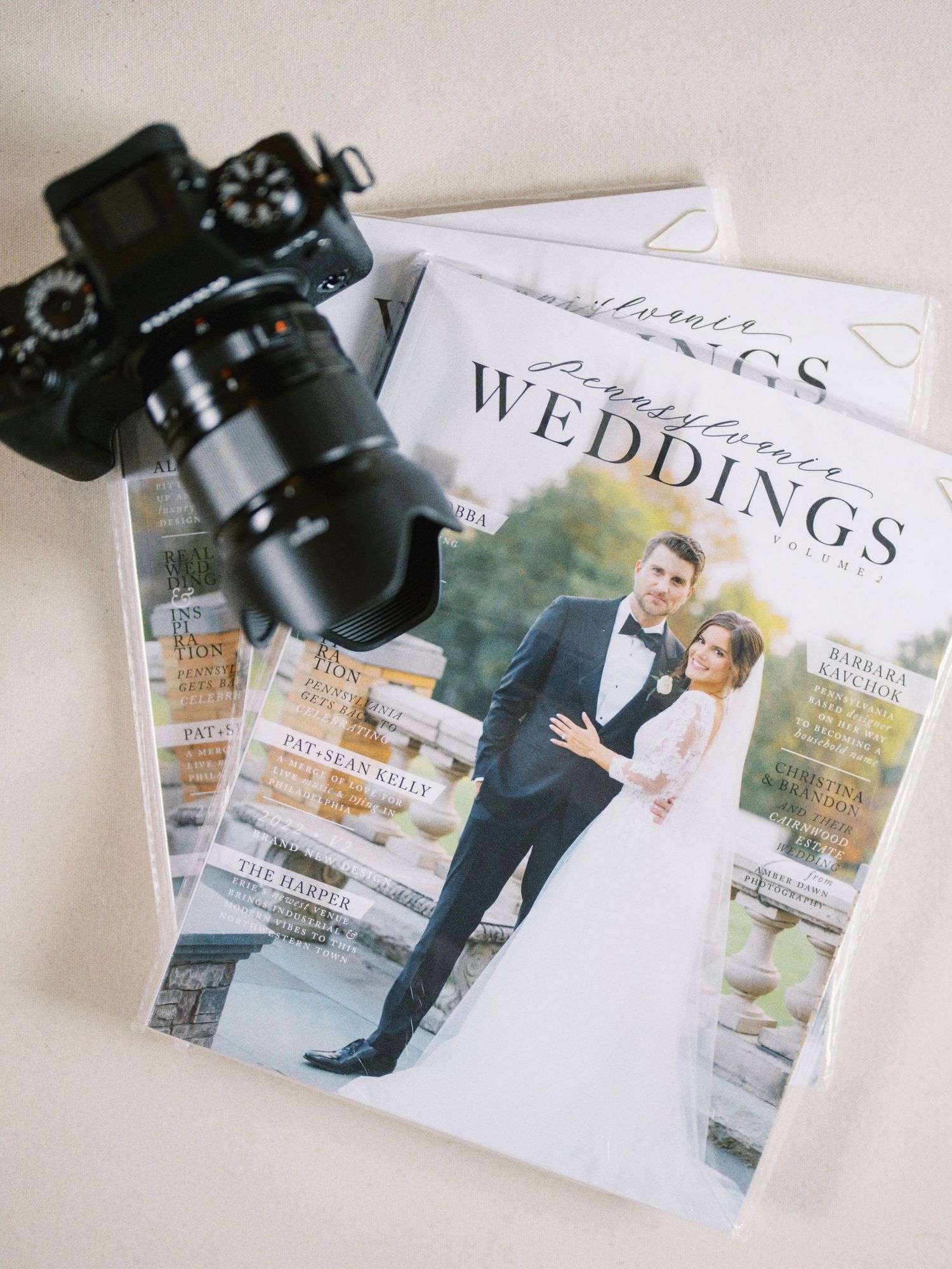Wedding photography magazine and professional camera on white background.