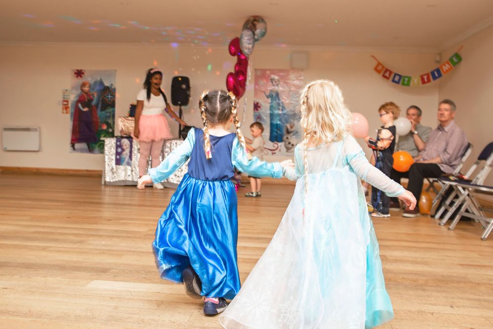 Birthday girl dancing at frozen themed party