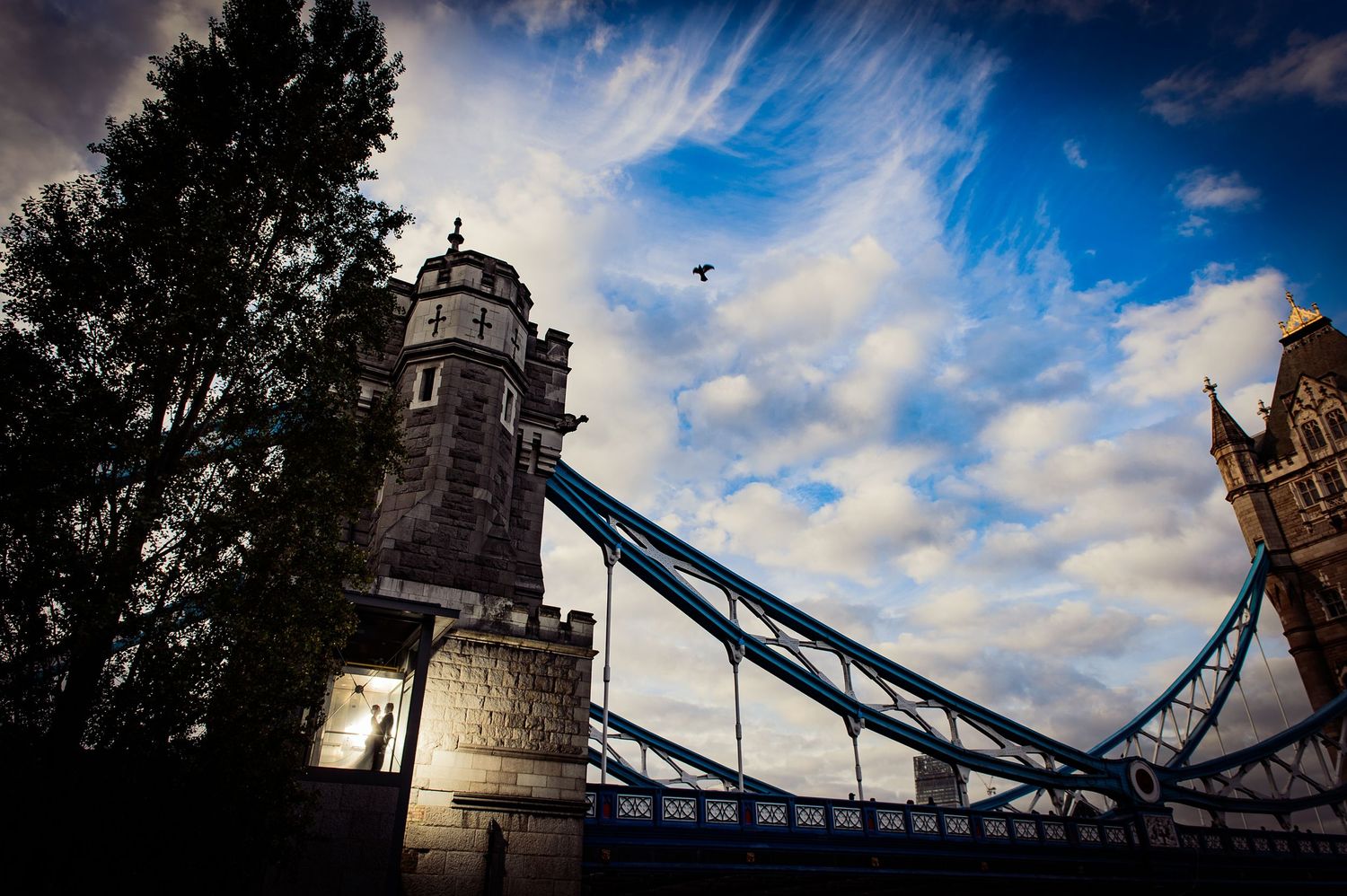 Dramatic skies above Tower Bridge framing couple