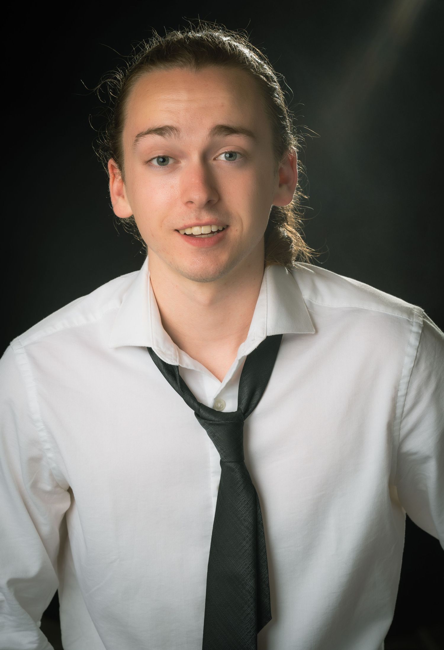 Sheldon Hall in white dress shirt and black tie in a headshot