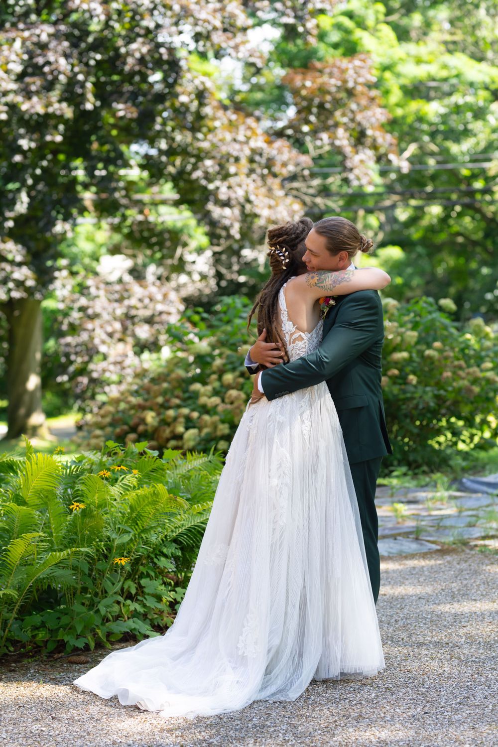 A tender moment between newlyweds embracing in a blooming garden setting.