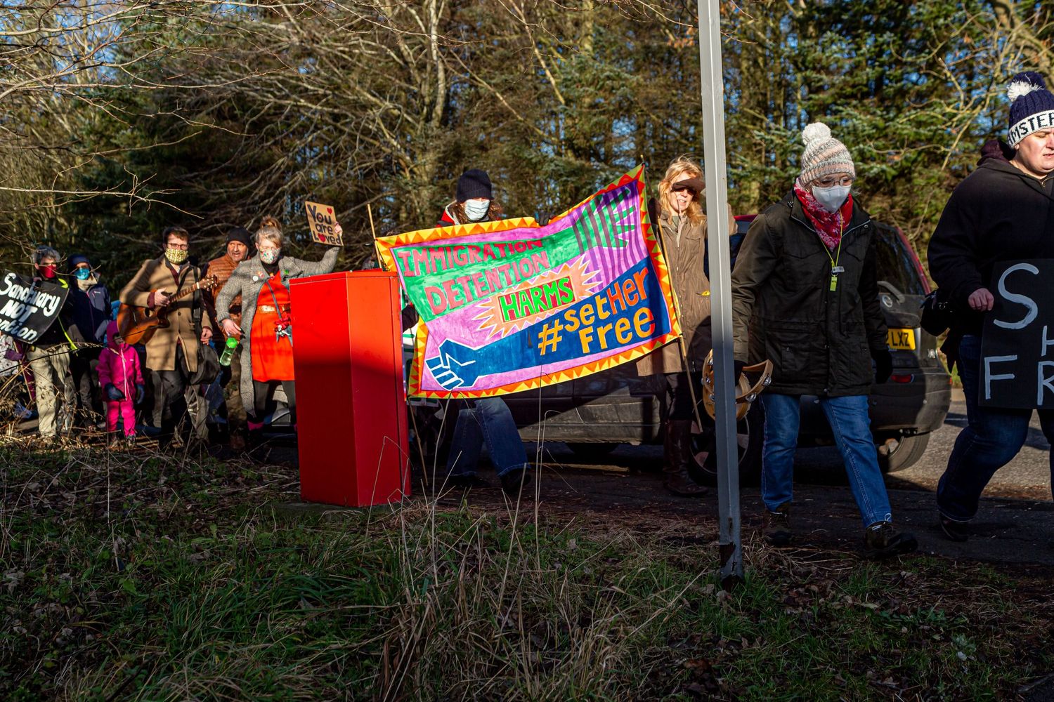 Campaigners walking aroound the IRC site in solidarity, singing #SetHerFree