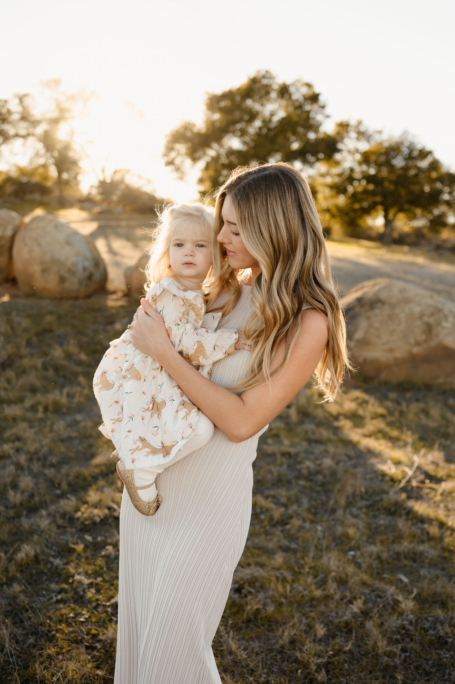 Santa Barbara Mommy & Me photos by Ventura family Photographer of woman cuddling daughter in grassy field