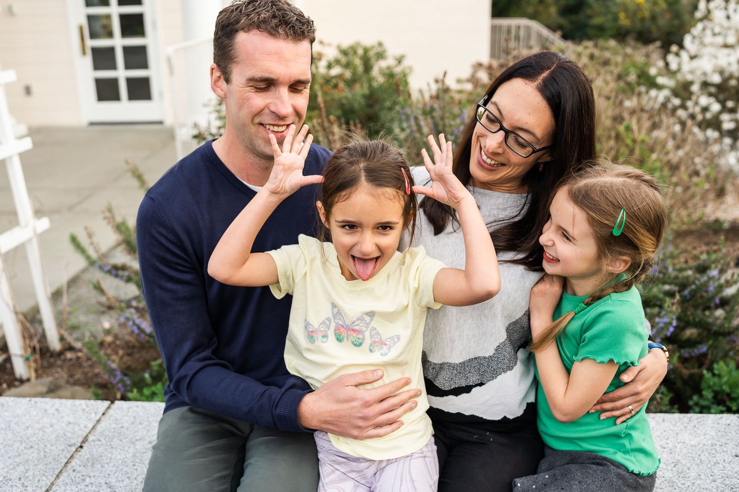 Daughter making a silly face at family photos.