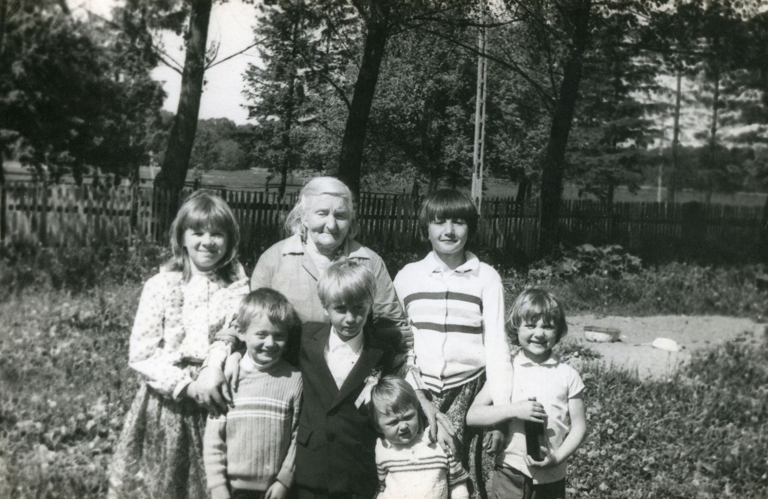 Black and white vintage photograph of a family group gathered outdoors.