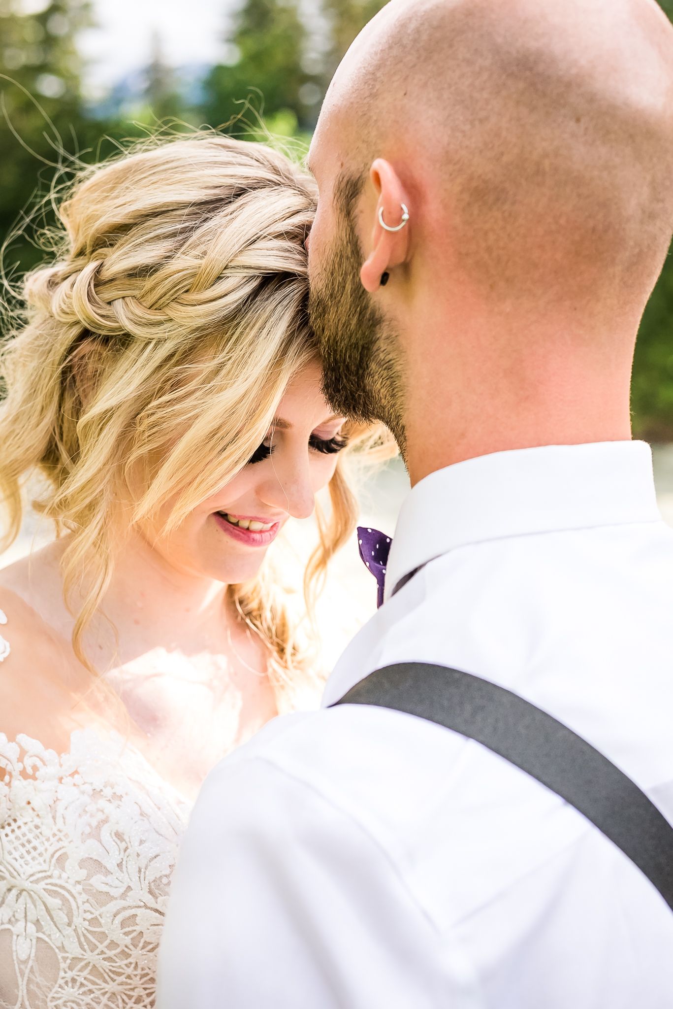 A groom lovingly kisses his bride on the forehead. Photo taken in Vancouver by Kari Mills Photography.