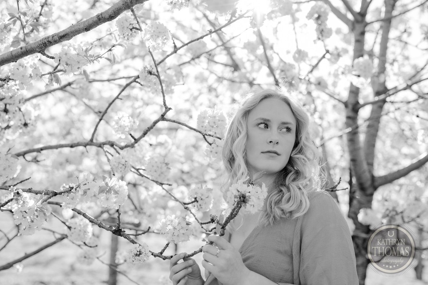 Black and white portrait among blooming cherry blossoms.