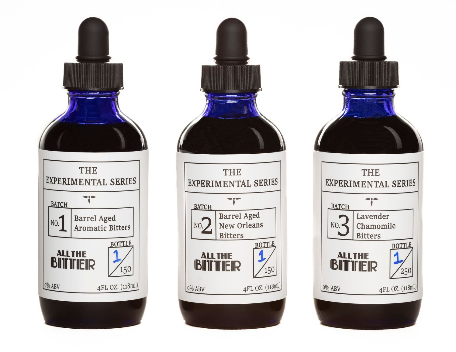 Set of three labeled experimental dropper bottles containing dark liquid.