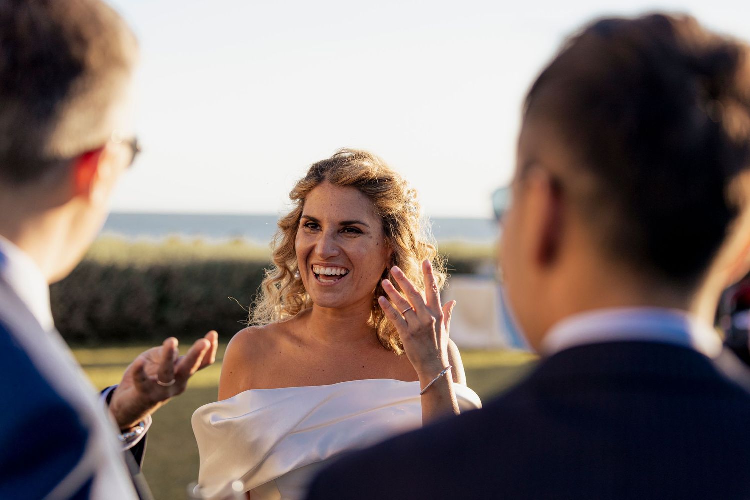 Wedding celebration with guests enjoying conversation outdoors.