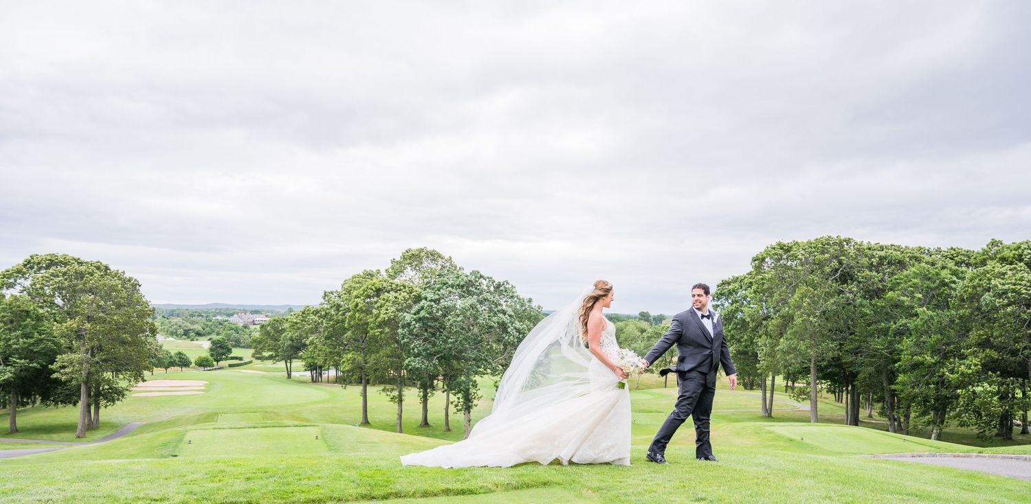 The couple walks hand in hand through the beautiful Golf Course at Giorgio's