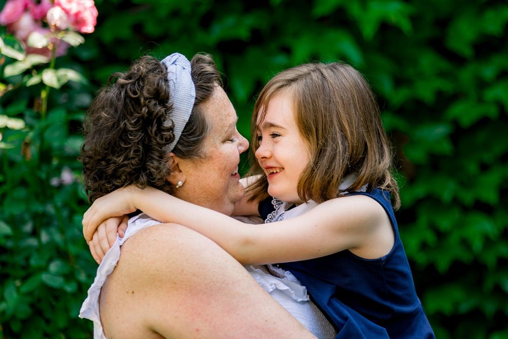 Mother and daughter lifestyle hugging and laughing together.
