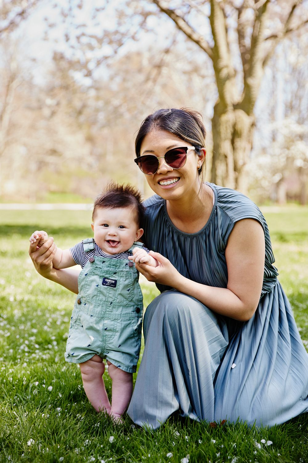 Mommy and baby boy photography in the park with apple blossom trees.