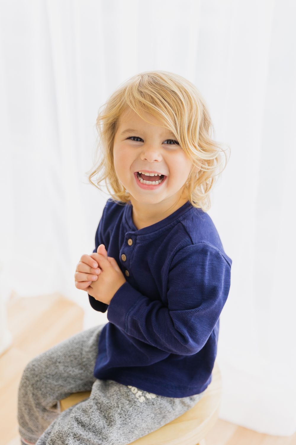 Happy toddler in a natural light studio space.