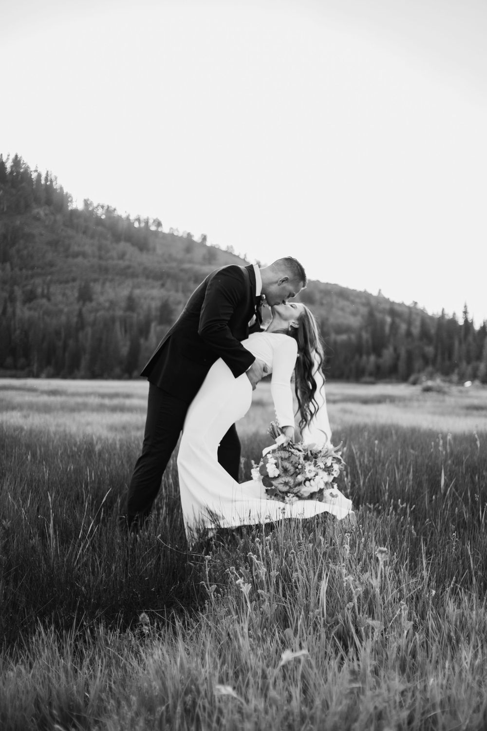 timeless couple kissing in missouri grasslands